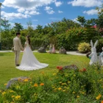 A bride and groom holding hands on a lush green lawn, highlighting the scenic garden wedding venue at Wondellea