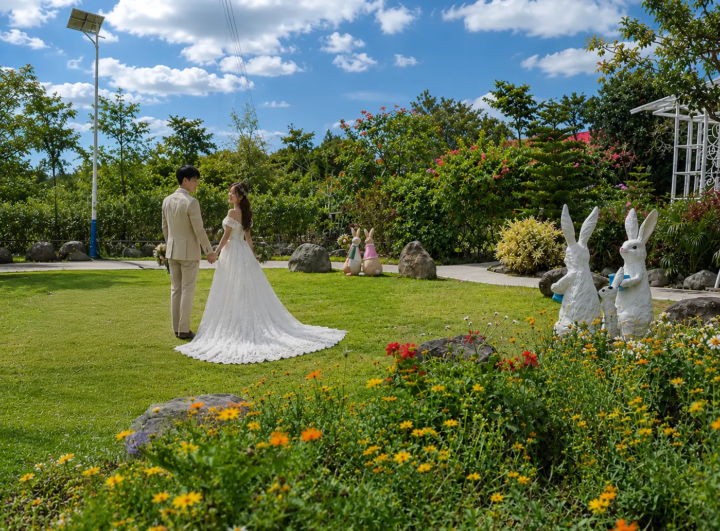 A bride and groom holding hands on a lush green lawn, highlighting the scenic garden wedding venue at Wondellea