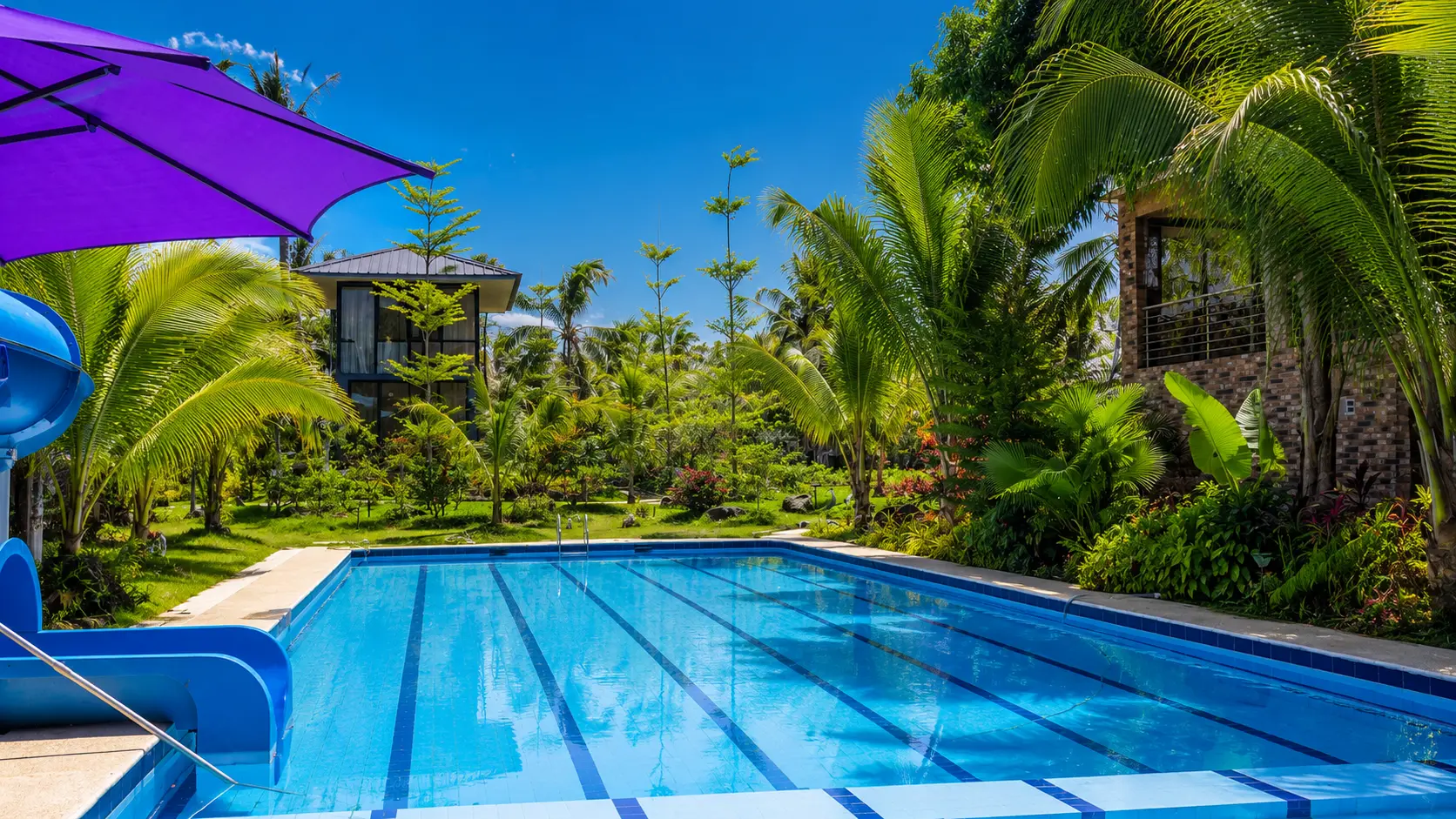 Outdoor swimming pool at an event place in Cavite with pool surrounded by lush palms.