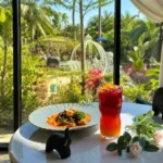 Coffee, pastry, and iced drink by a garden view at the best coffee shop in Cavite