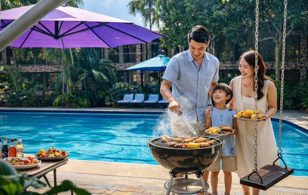 A family bonding by a brick grill station under a wooden pergola in the barbeque area at Wondellea