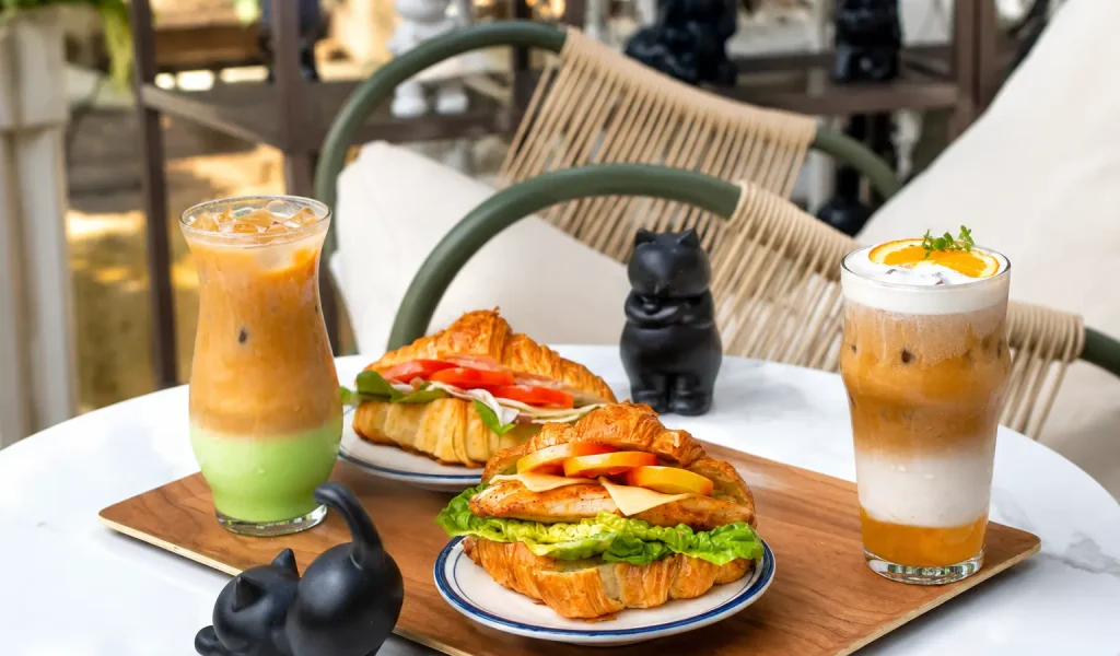 Croissant sandwiches and iced drinks displayed at a stylish cafe in Cavite