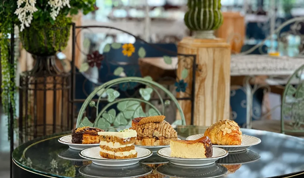 Assorted cakes and pastries on a glass table at Wondellea Cafe & Resort, known as the best cafe in Silang Cavite.