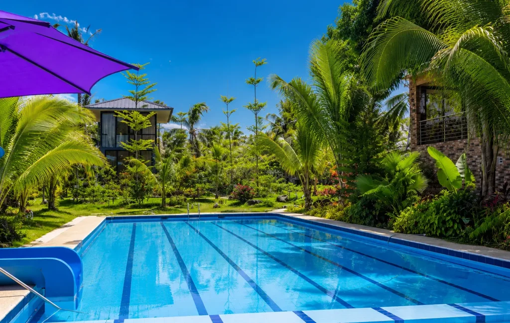 Crystal-clear outdoor resort swimming pool surrounded by green landscapes at Wondellea