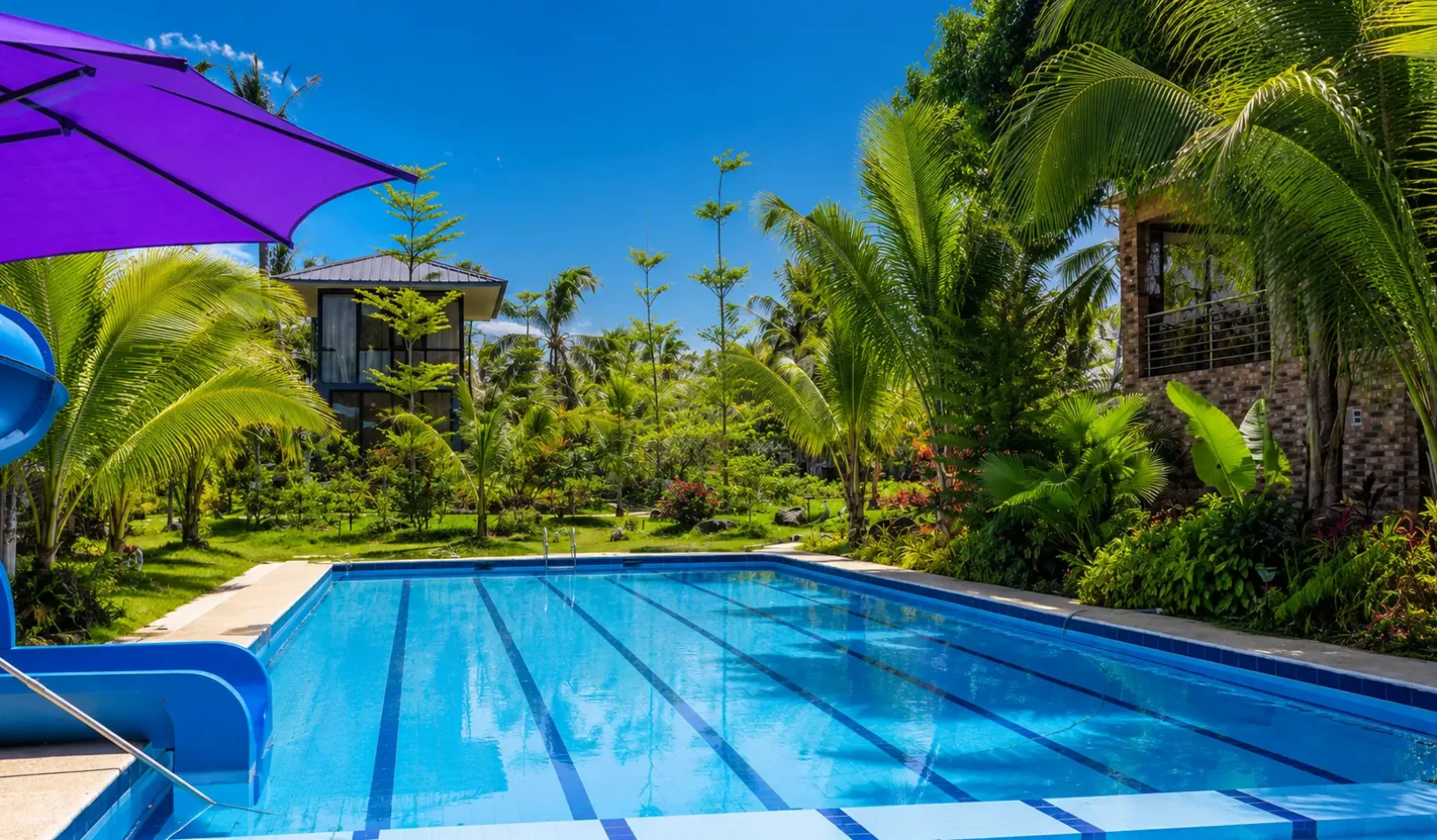 Crystal-clear outdoor resort swimming pool surrounded by green landscapes at Wondellea