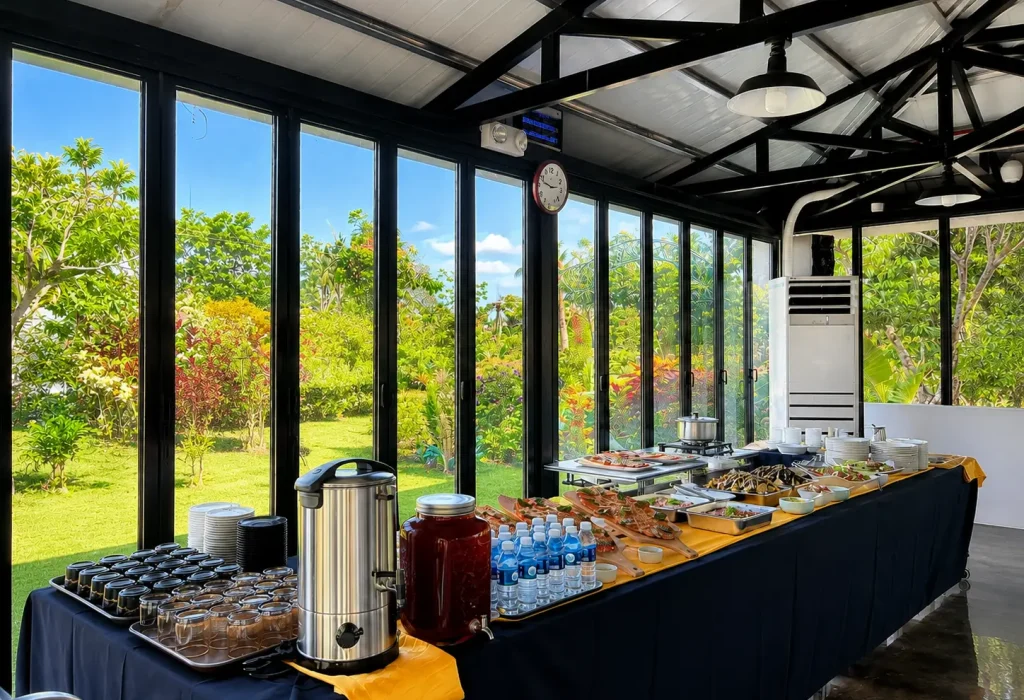 A long catering table lined with delicious dishes and refreshments inside the bright seminar room at Wondellea
