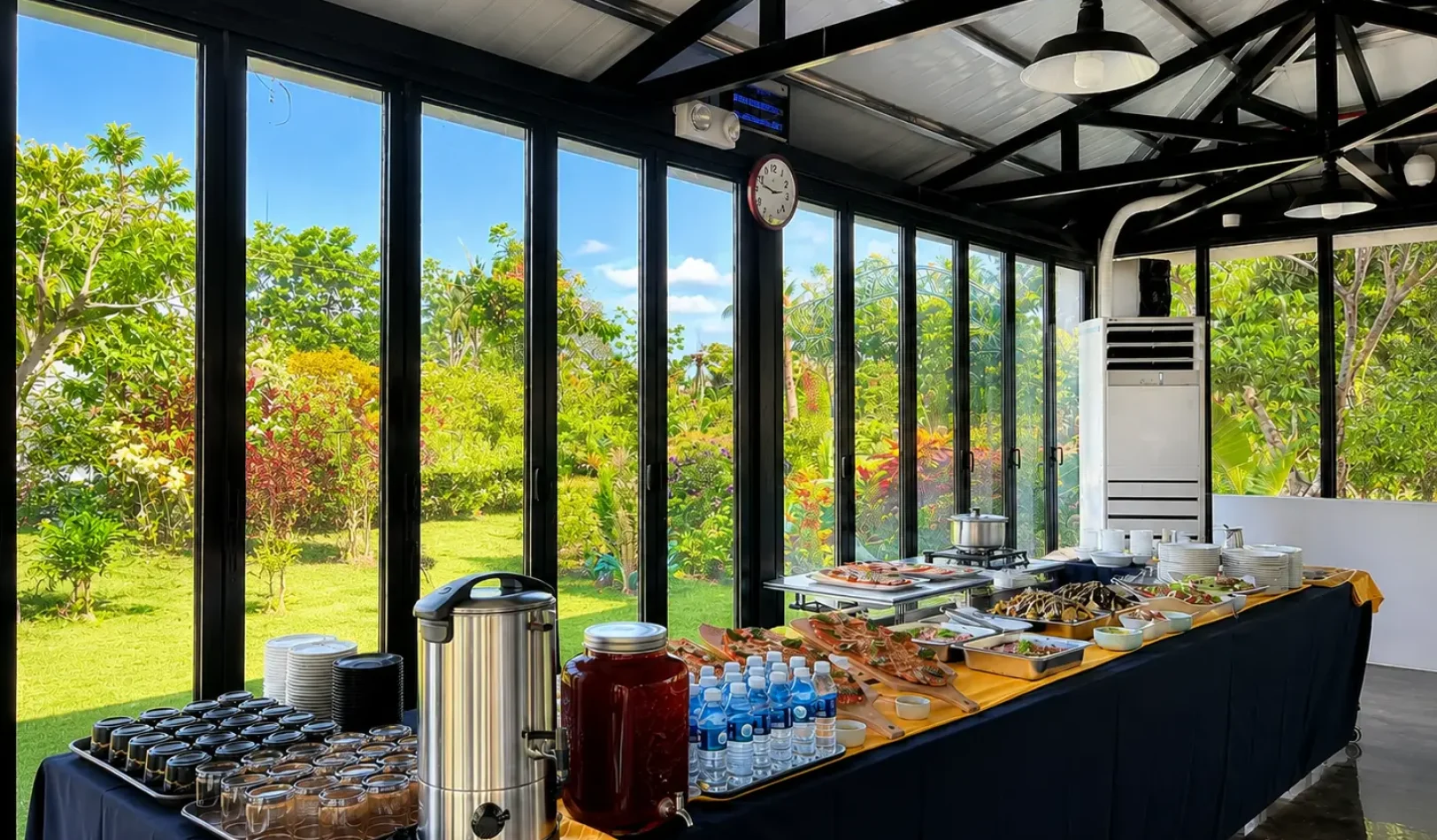 A long catering table lined with delicious dishes and refreshments inside the bright seminar room at Wondellea