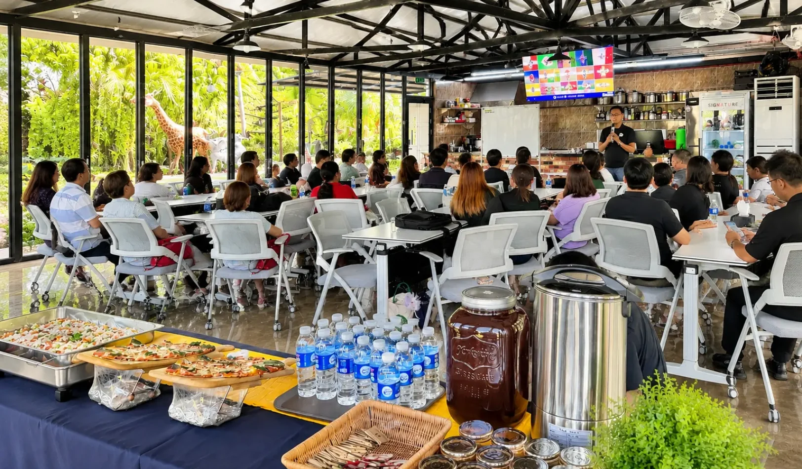 A corporate seminar and gathering held inside a spacious, glass-walled meeting room with catering at Wondellea